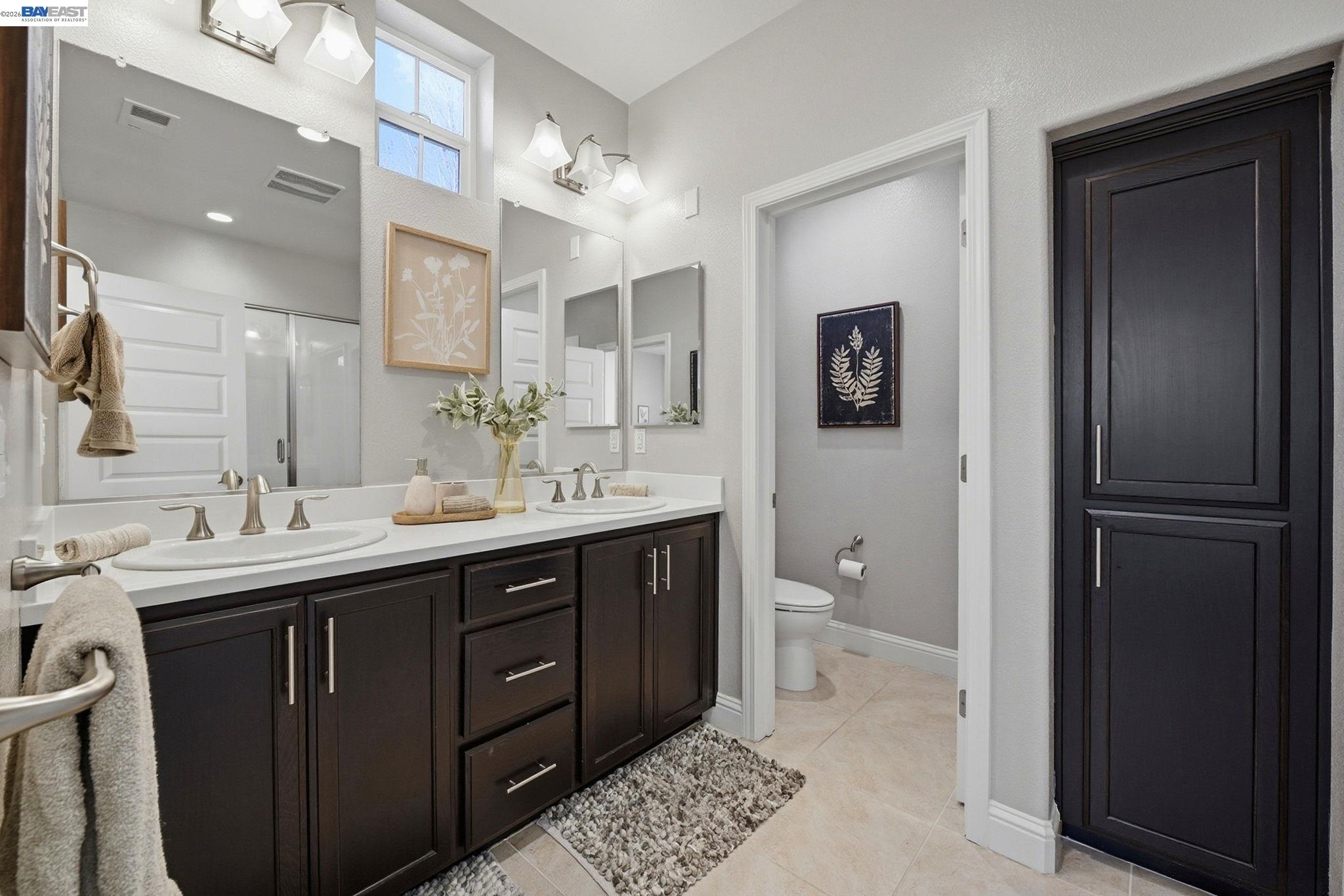 287 Wild Rose Way Milpitas, CA 95035 - Photo 30 of 45 a spacious bathroom with a double vanity sink a toilet and a mirror