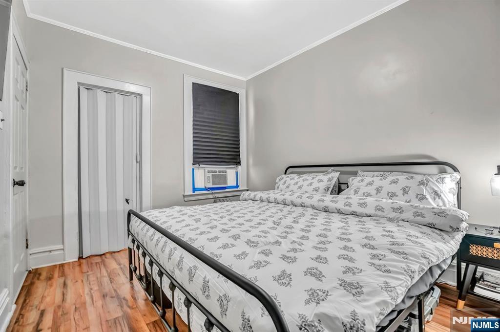 699 Elm Street Kearny, NJ 07032 - Photo 24 of 37 a bedroom with a bed and wooden floor