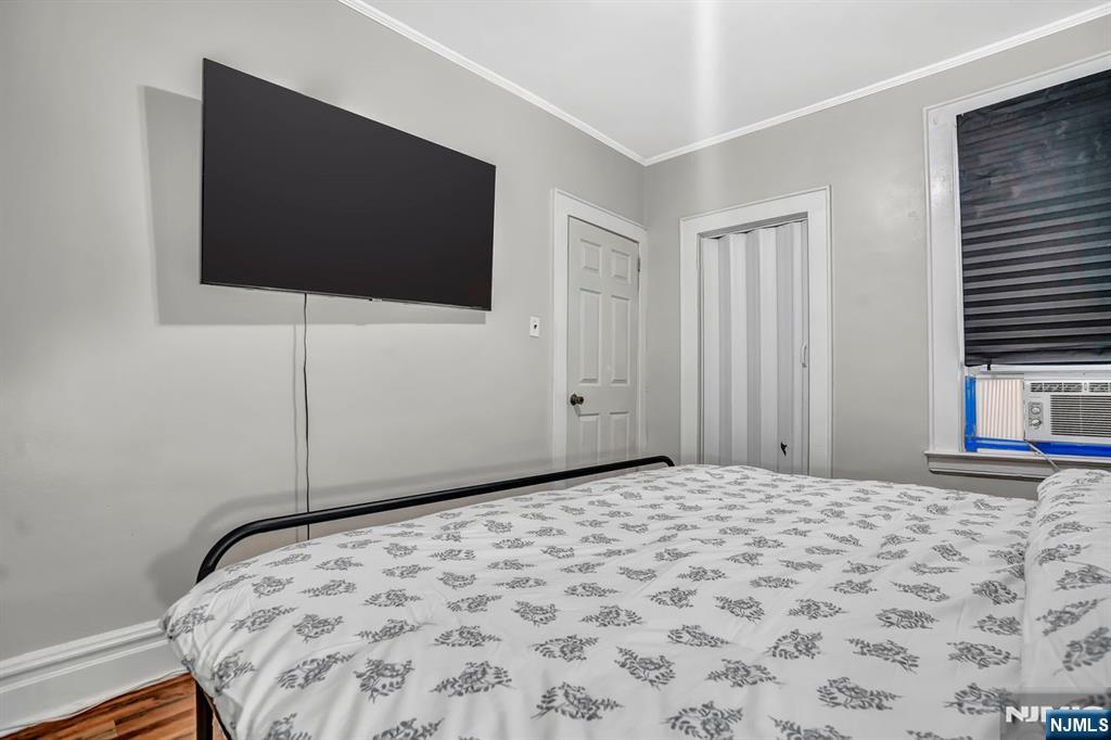699 Elm Street Kearny, NJ 07032 - Photo 25 of 37 a bedroom with a bed and a flat screen tv