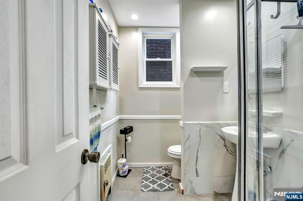 699 Elm Street Kearny, NJ 07032 - Photo 27 of 37 a bathroom with a bathtub and a shower