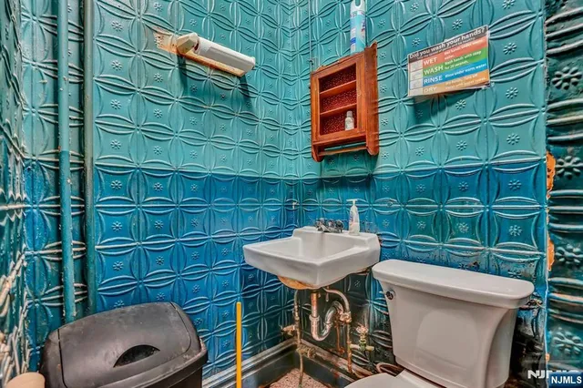 a bathroom with a sink a toilet and mirror