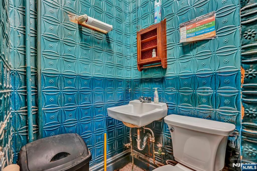 699 Elm Street Kearny, NJ 07032 - Photo 7 of 37 a bathroom with a sink a toilet and mirror