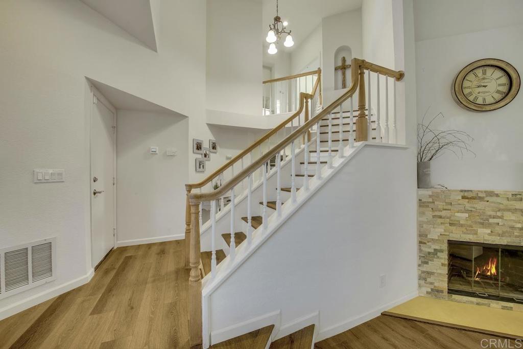 5068 Nighthawk Way Oceanside, CA 92056 - Photo 5 of 39 a view of a hallway with wooden floor and staircase