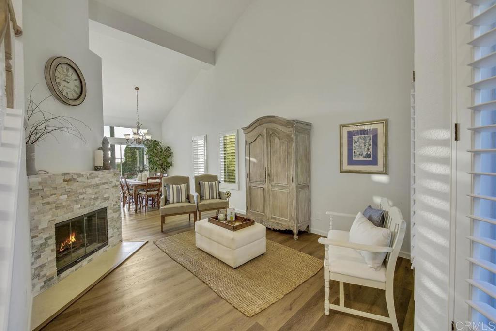 5068 Nighthawk Way Oceanside, CA 92056 - Photo 6 of 39 a living room with furniture a fireplace and a clock