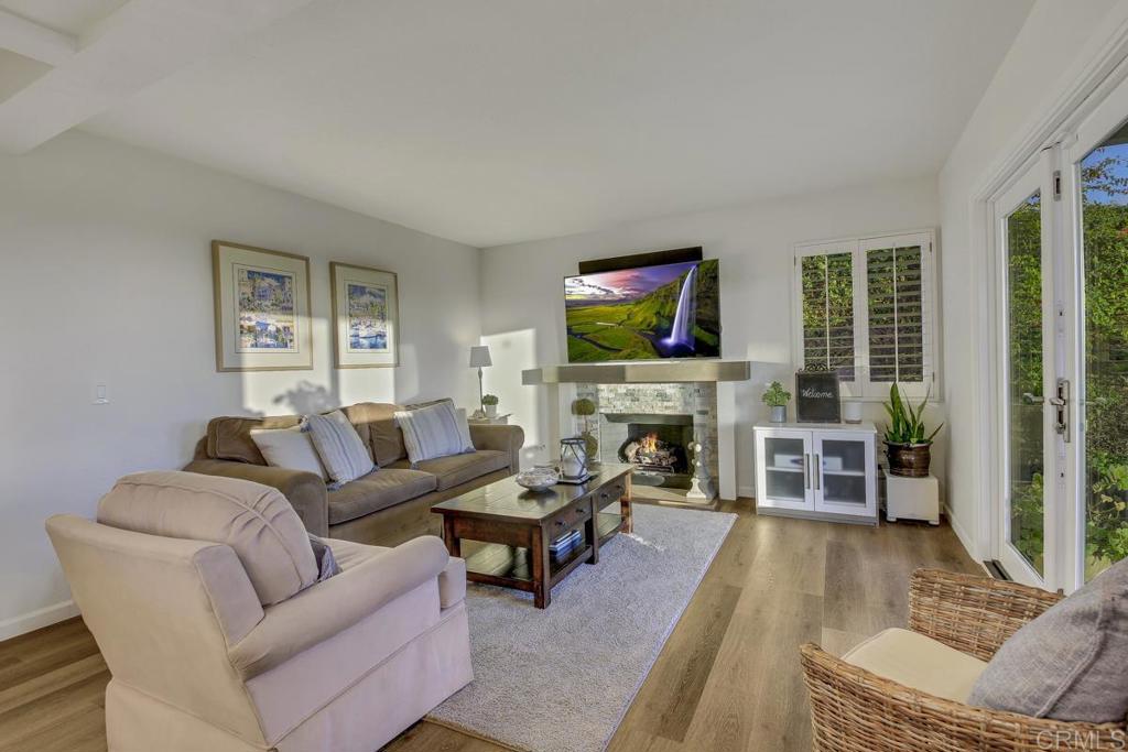 5068 Nighthawk Way Oceanside, CA 92056 - Photo 10 of 39 a living room with furniture a flat screen tv and a fireplace