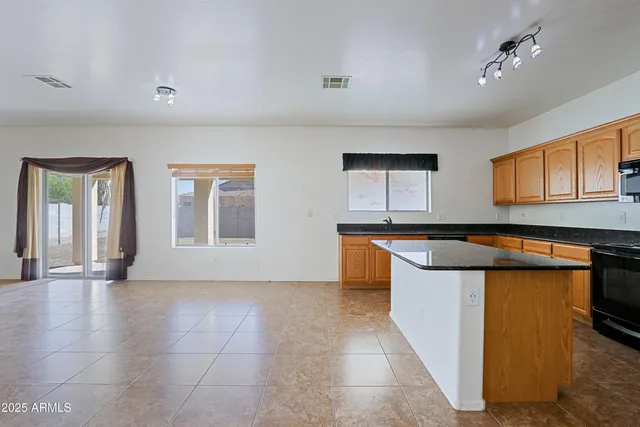 a kitchen with stainless steel appliances granite countertop a sink and cabinets