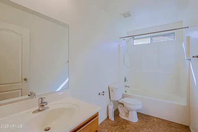 a white toilet sitting next to a bathroom sink