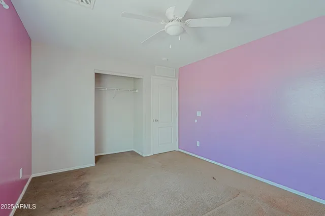 an empty room with a ceiling fan