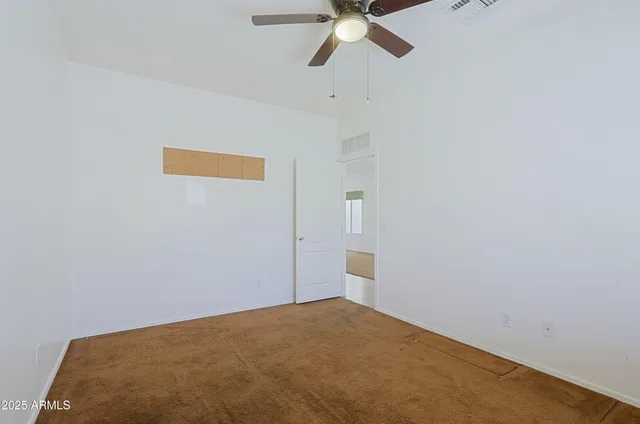 a view of a room with a ceiling fan