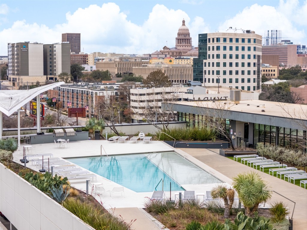 Community pool with a patio area and a view of city