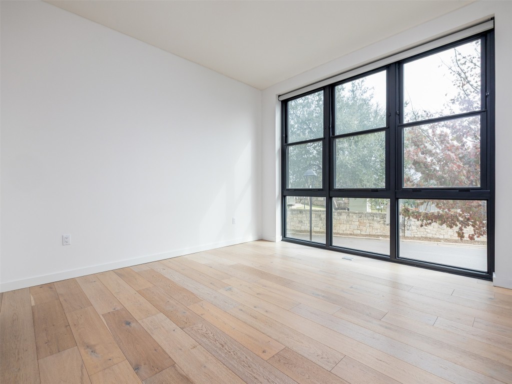 800 Embassy Drive, Unit 237 Austin, TX 78702 - Photo 12 of 35 Main bedroom with floor to ceiling windows and electric shades
