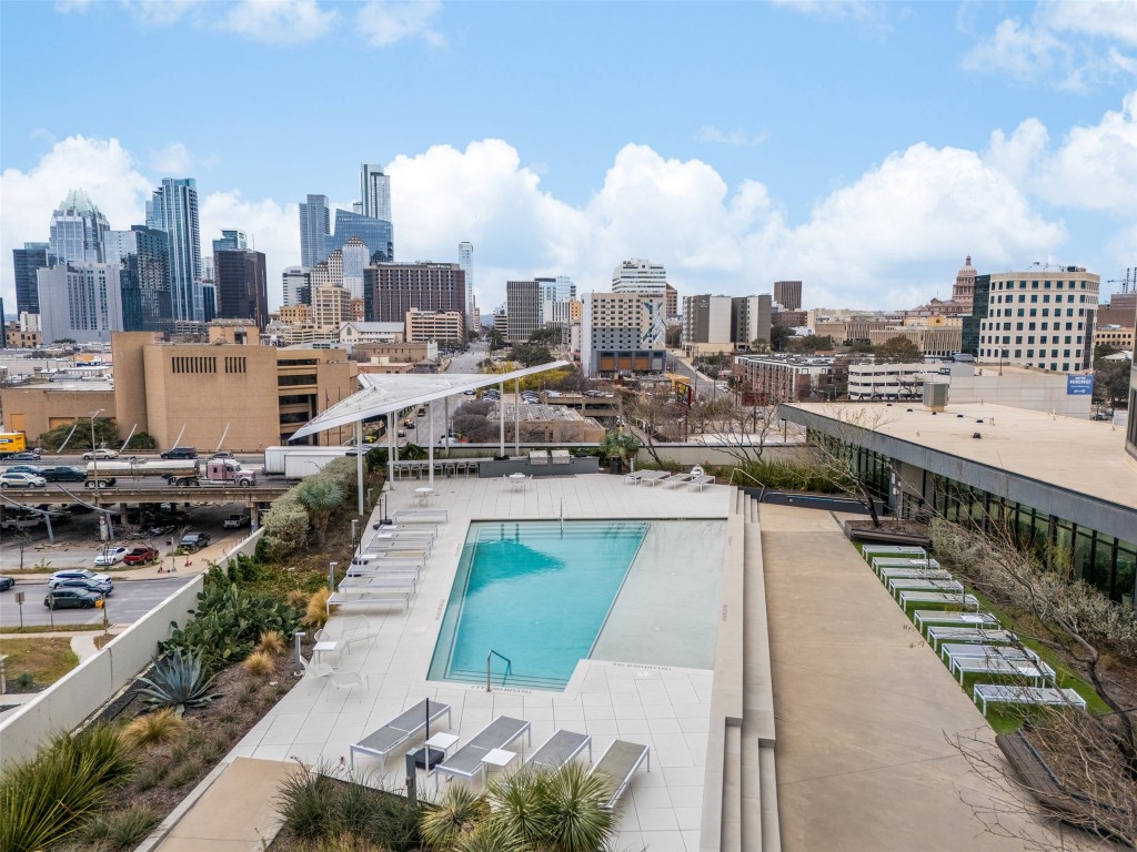 800 Embassy Drive, Unit 237 Austin, TX 78702 - Photo 24 of 35 Community pool with a view of skyline and a patio