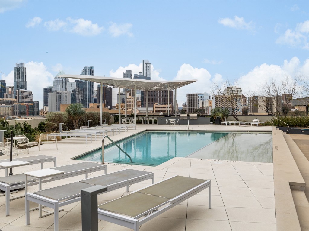 800 Embassy Drive, Unit 237 Austin, TX 78702 - Photo 26 of 35 Community pool with a view of skyline and a patio
