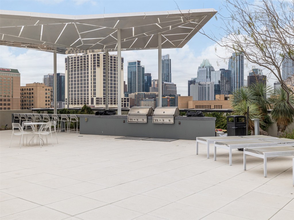 800 Embassy Drive, Unit 237 Austin, TX 78702 - Photo 28 of 35 View of patio / terrace with area for grilling, a skyline view, and outdoor dining area