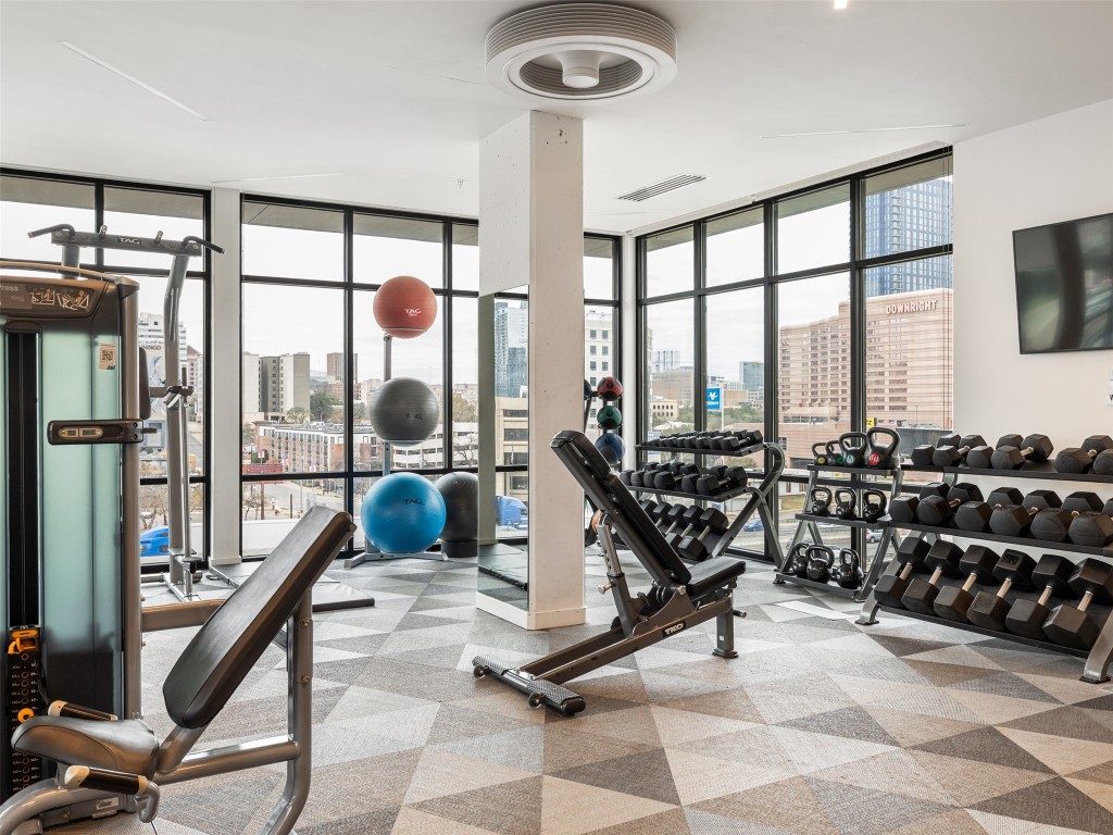 800 Embassy Drive, Unit 237 Austin, TX 78702 - Photo 34 of 35 Workout area featuring a view of city and expansive windows