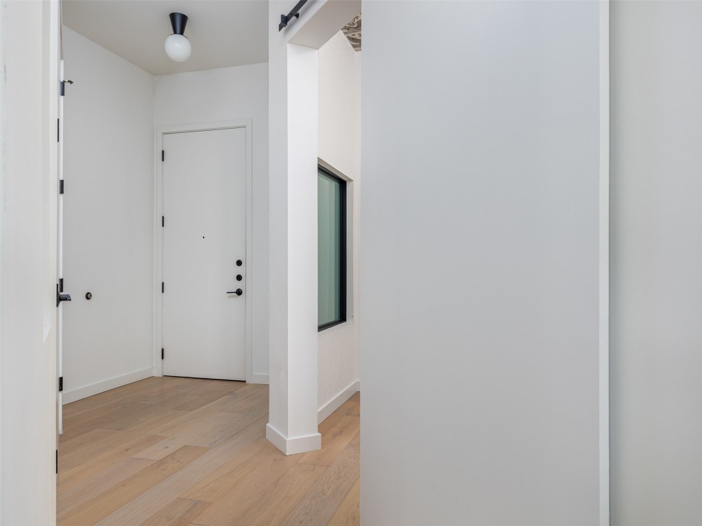 800 Embassy Drive, Unit 237 Austin, TX 78702 - Photo 8 of 35 Foyer with light wood-style flooring and a barn door