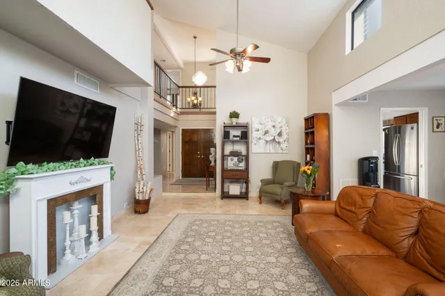a dining room with furniture and large windows