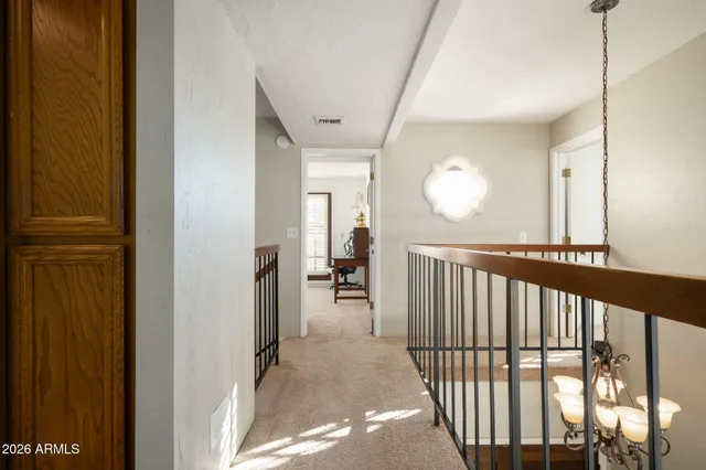 a bedroom with a bed a window and a flat screen tv