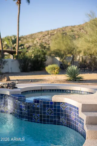 a view of a patio with table and chairs with wooden floor and fence