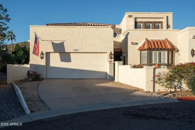 a view of a lush green hillside and a houses