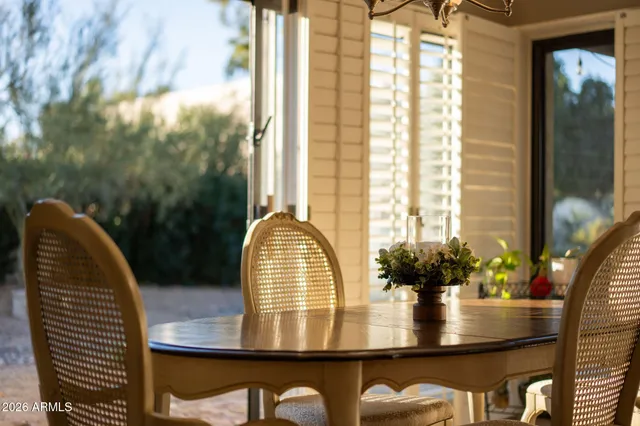 a living room with furniture and large windows