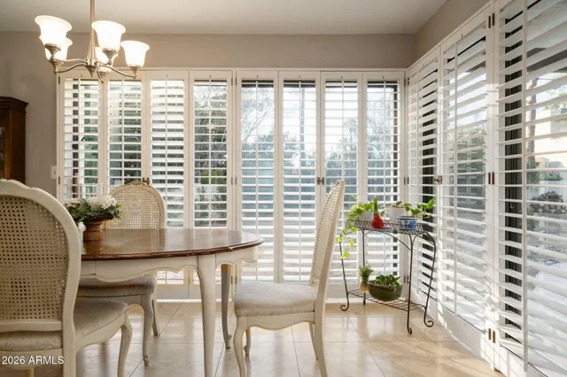 a view of a dining room with furniture and a window
