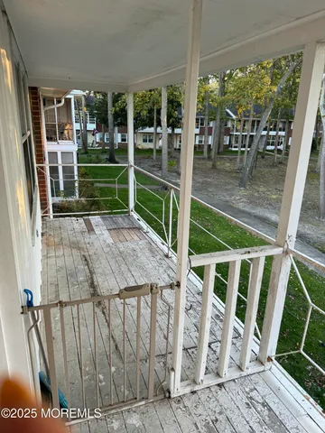 a view of deck with furniture and garden
