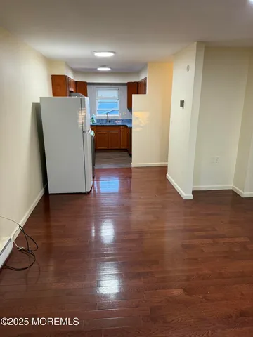 a view of kitchen and wooden floor