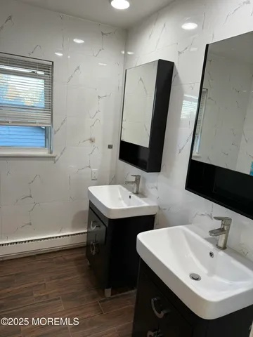 a bathroom with a sink double vanity and a mirror