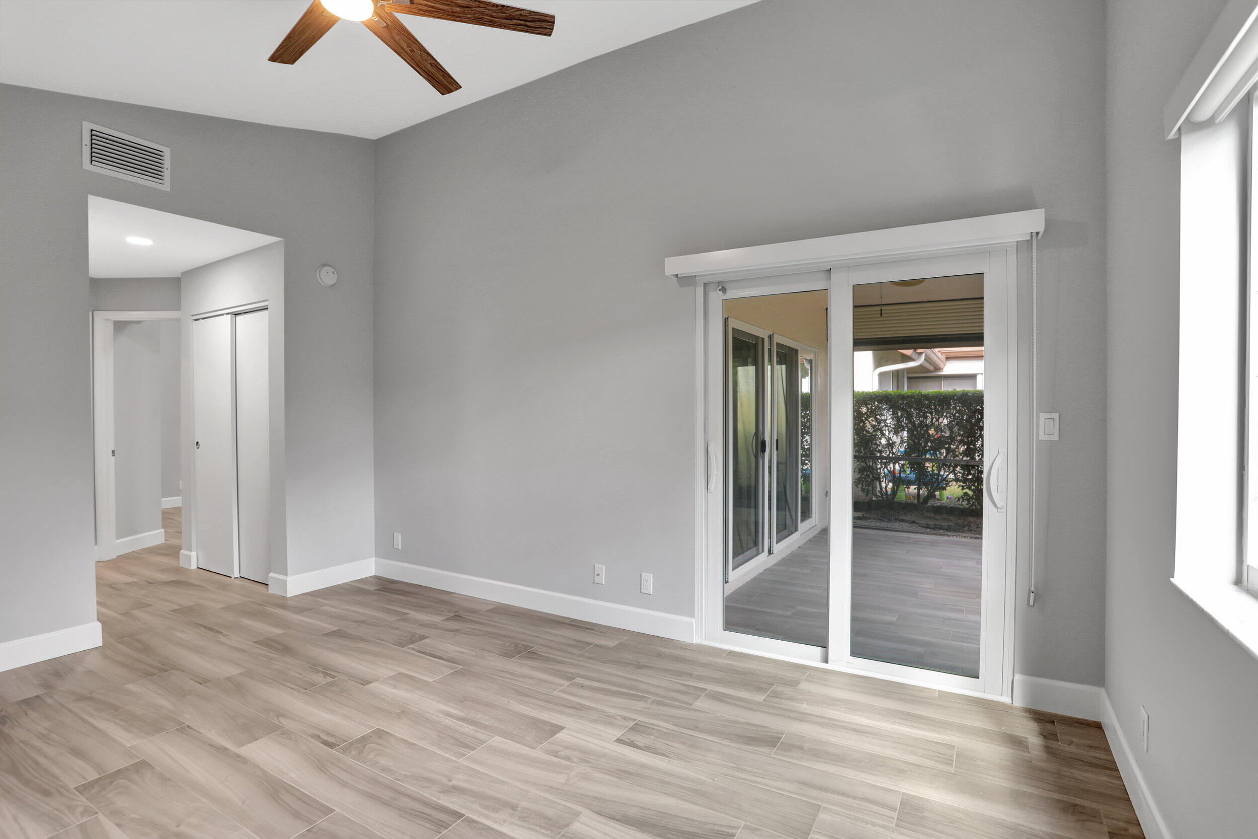 23271 Water Circle Boca Raton, FL 33486 - Photo 13 of 64 an empty room with wooden floor and windows