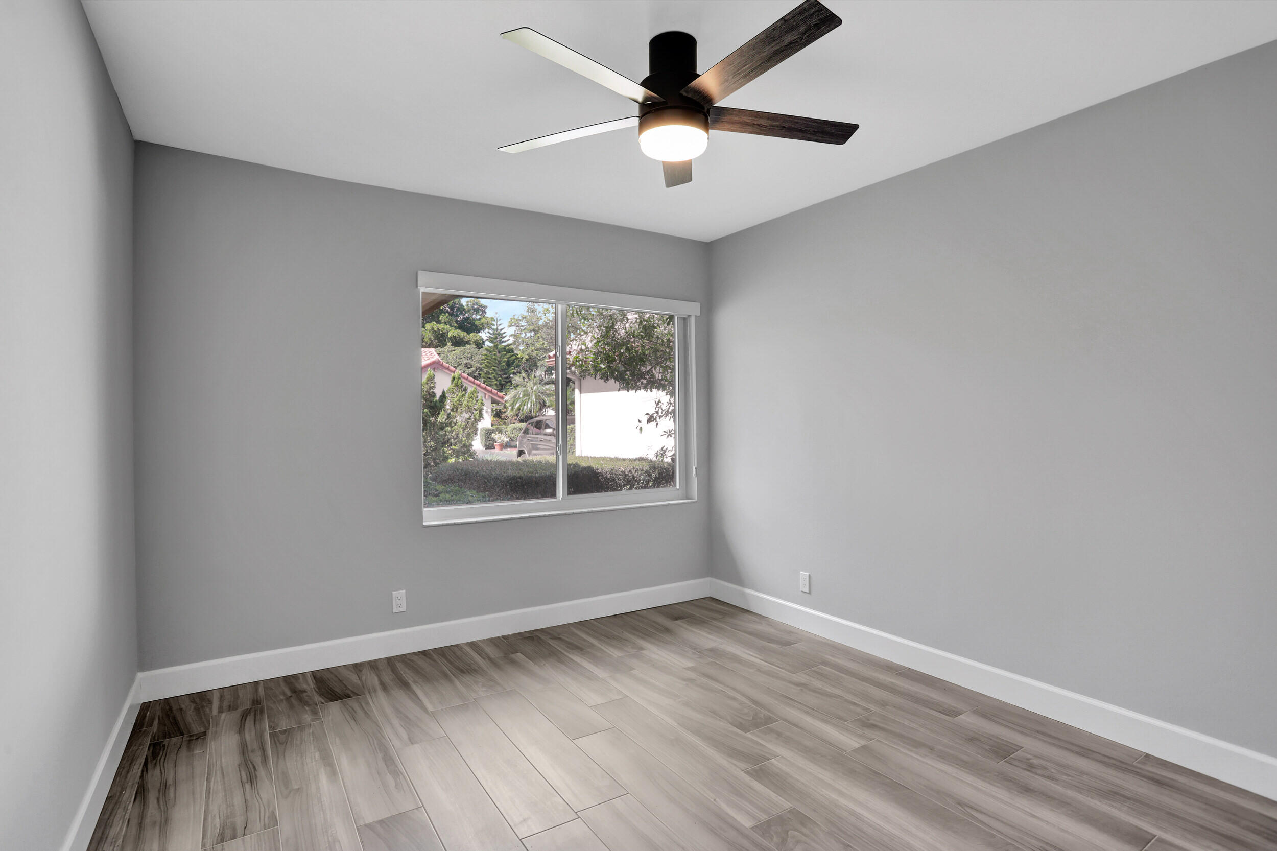 23271 Water Circle Boca Raton, FL 33486 - Photo 16 of 64 wooden floor in an empty room with a window