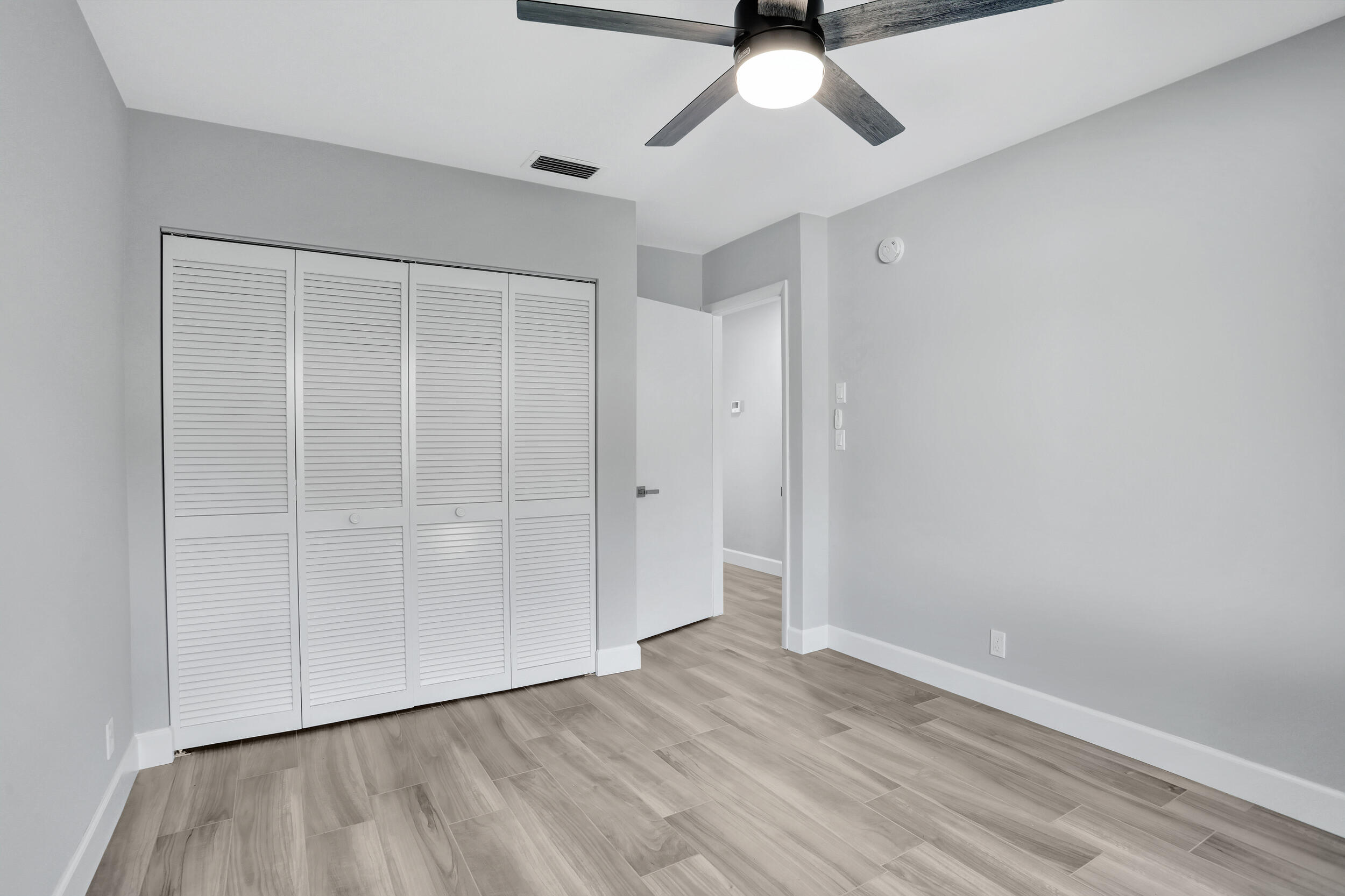 23271 Water Circle Boca Raton, FL 33486 - Photo 17 of 64 an empty room with a hardwood and ceiling fan