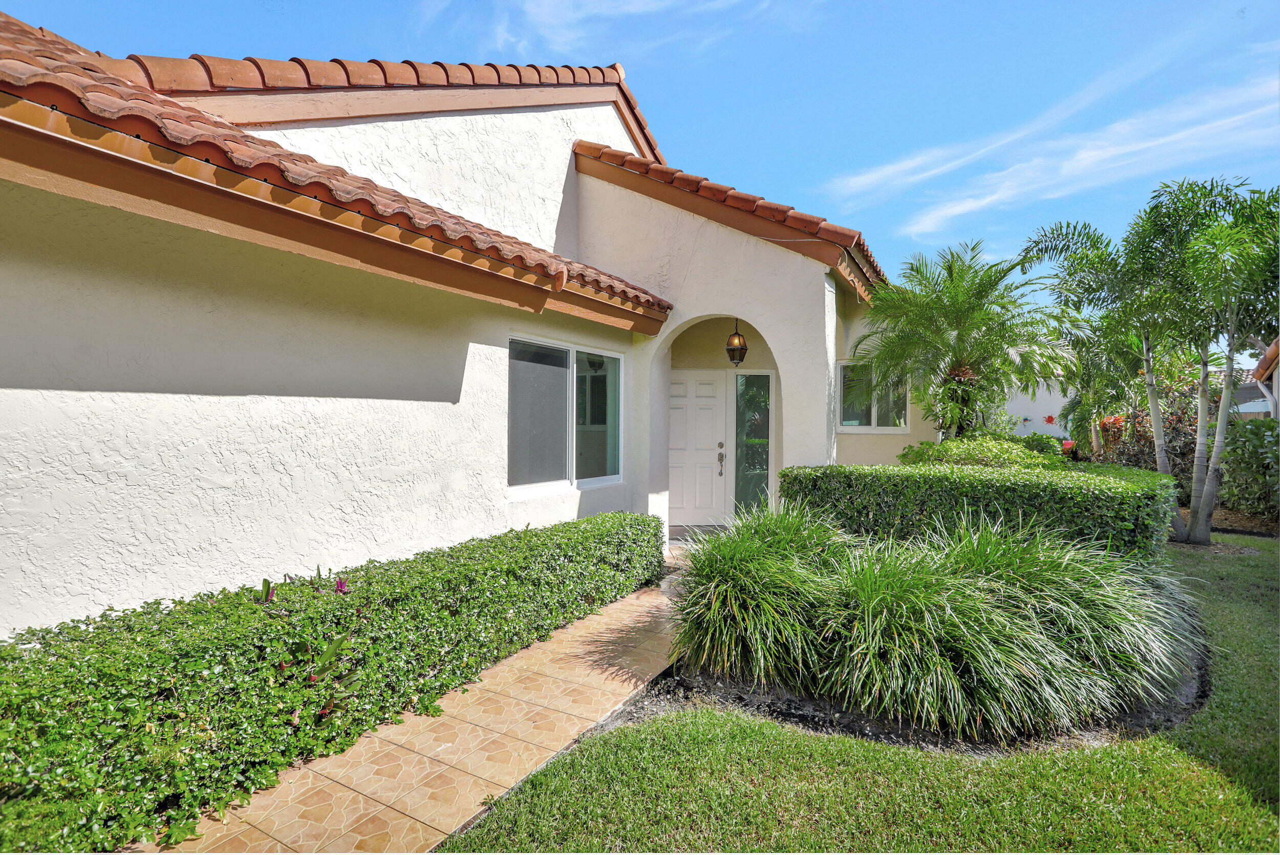 23271 Water Circle Boca Raton, FL 33486 - Photo 2 of 64 a front view of a house with a yard