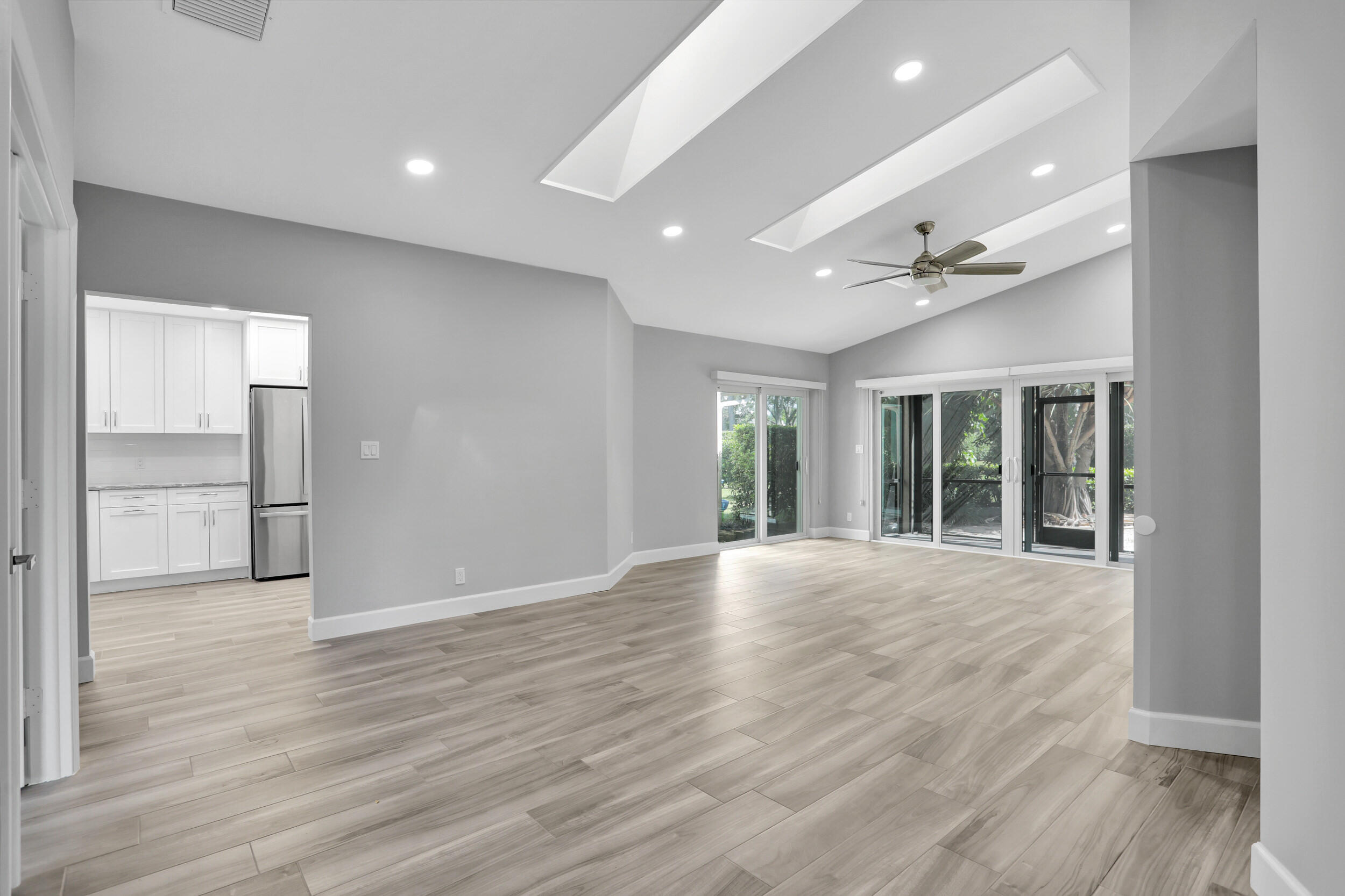 23271 Water Circle Boca Raton, FL 33486 - Photo 3 of 64 a view of an empty room with wooden floor and a window