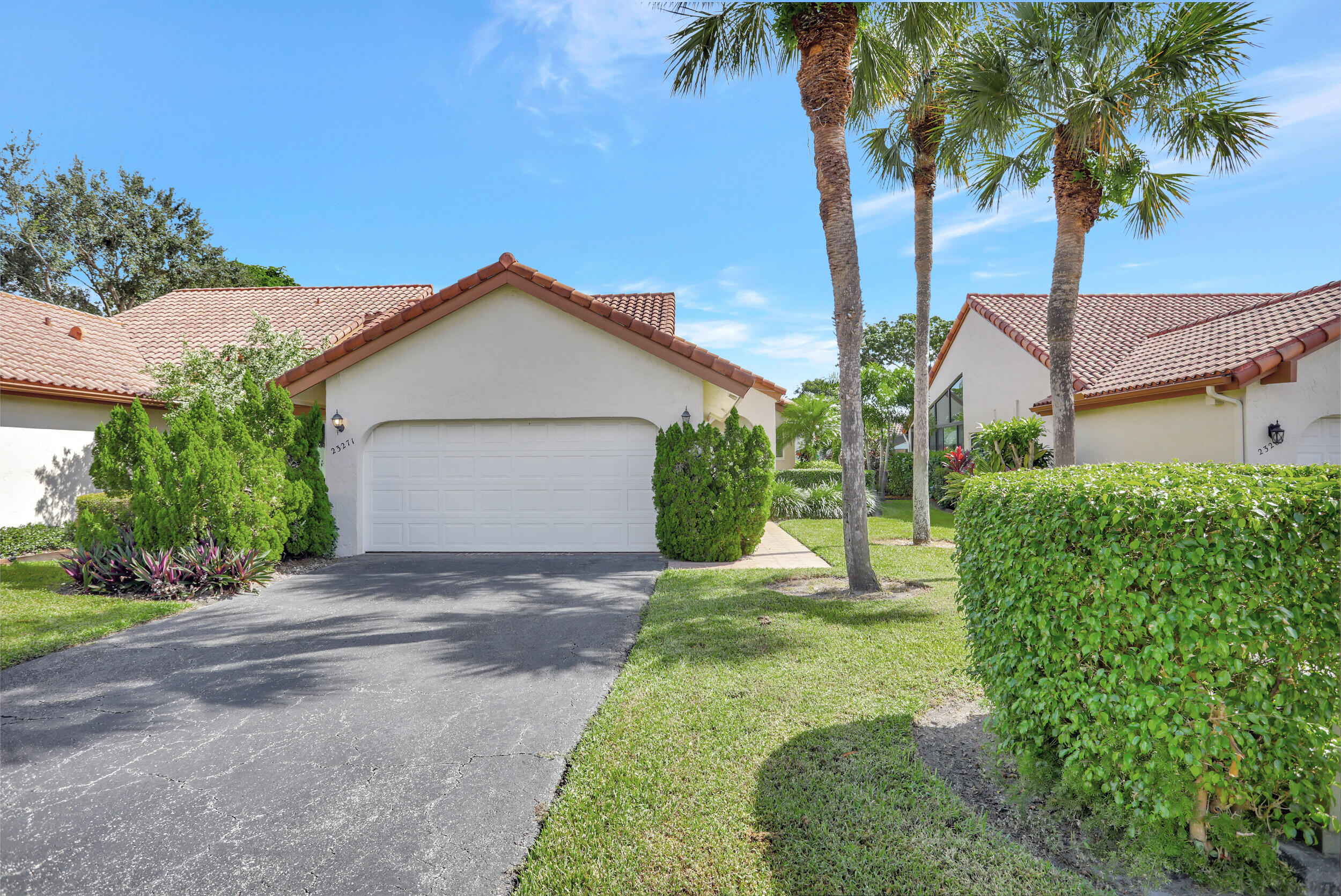 23271 Water Circle Boca Raton, FL 33486 - Photo 33 of 64 a front view of a house with a garden and tree