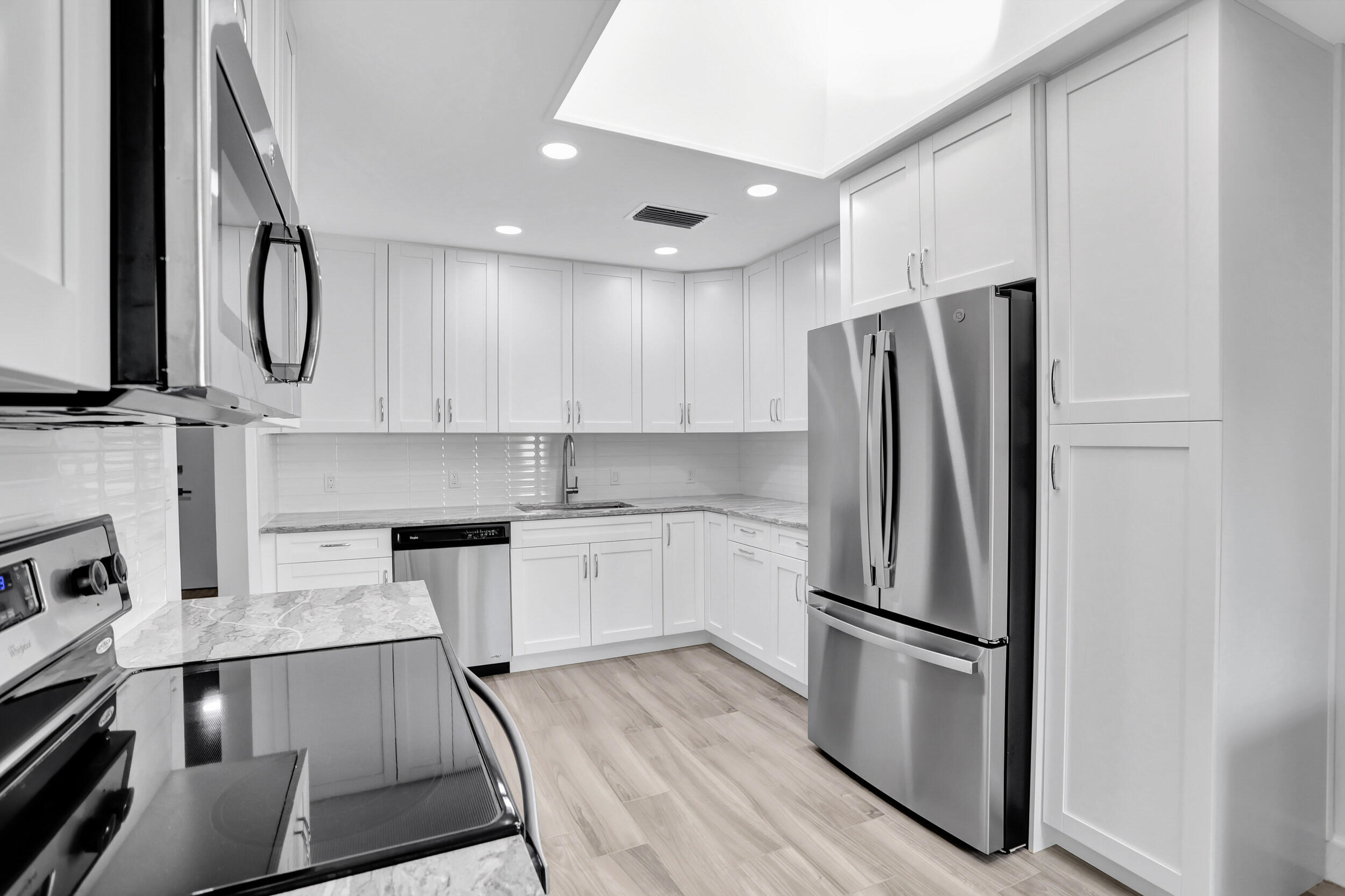 23271 Water Circle Boca Raton, FL 33486 - Photo 10 of 64 a kitchen with stainless steel appliances a refrigerator sink and white cabinets