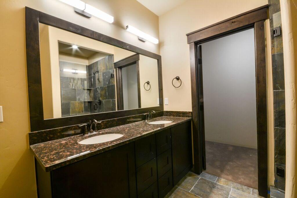 742 Independence Road, Unit 3B Keystone, CO 80435 - Photo 12 of 25 a bathroom with a granite countertop sink and a mirror