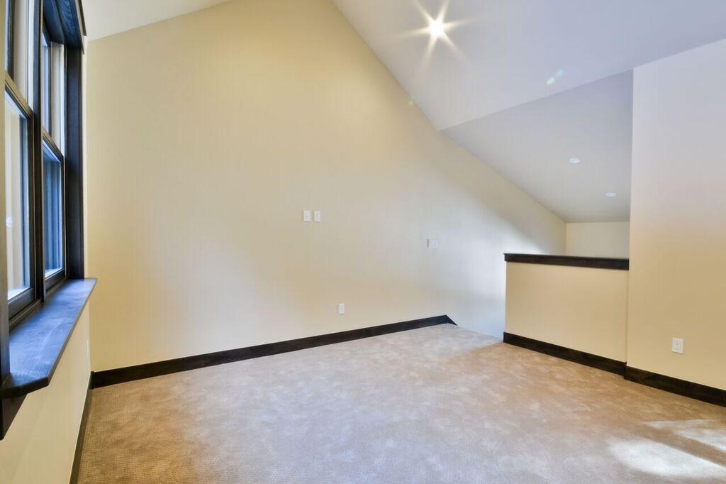 742 Independence Road, Unit 3B Keystone, CO 80435 - Photo 19 of 25 an empty room with wooden floor and windows