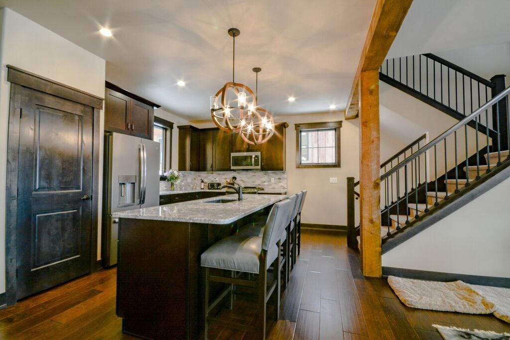 742 Independence Road, Unit 3B Keystone, CO 80435 - Photo 21 of 25 a view of a dining room with furniture and wooden floor