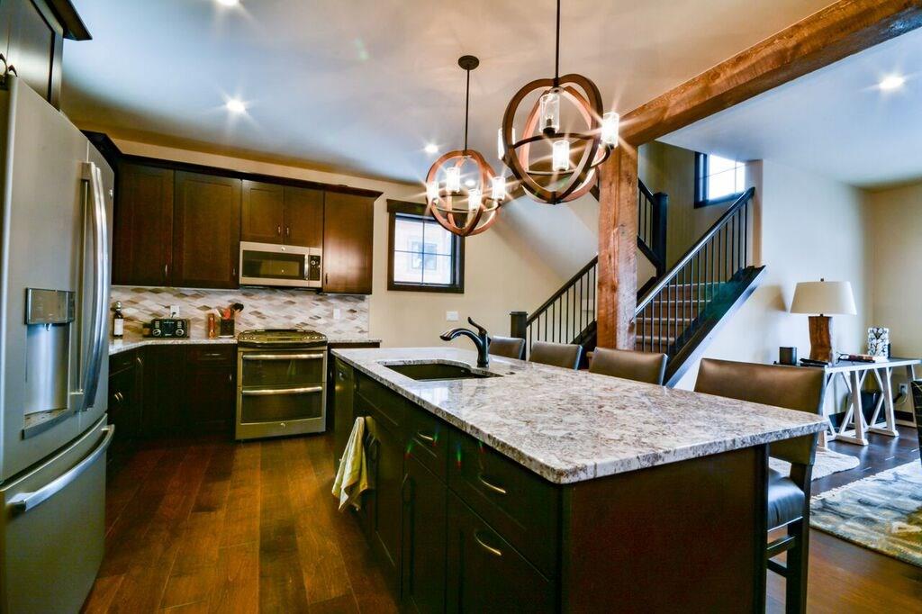 742 Independence Road, Unit 3B Keystone, CO 80435 - Photo 22 of 25 a kitchen with a table a sink and cabinets