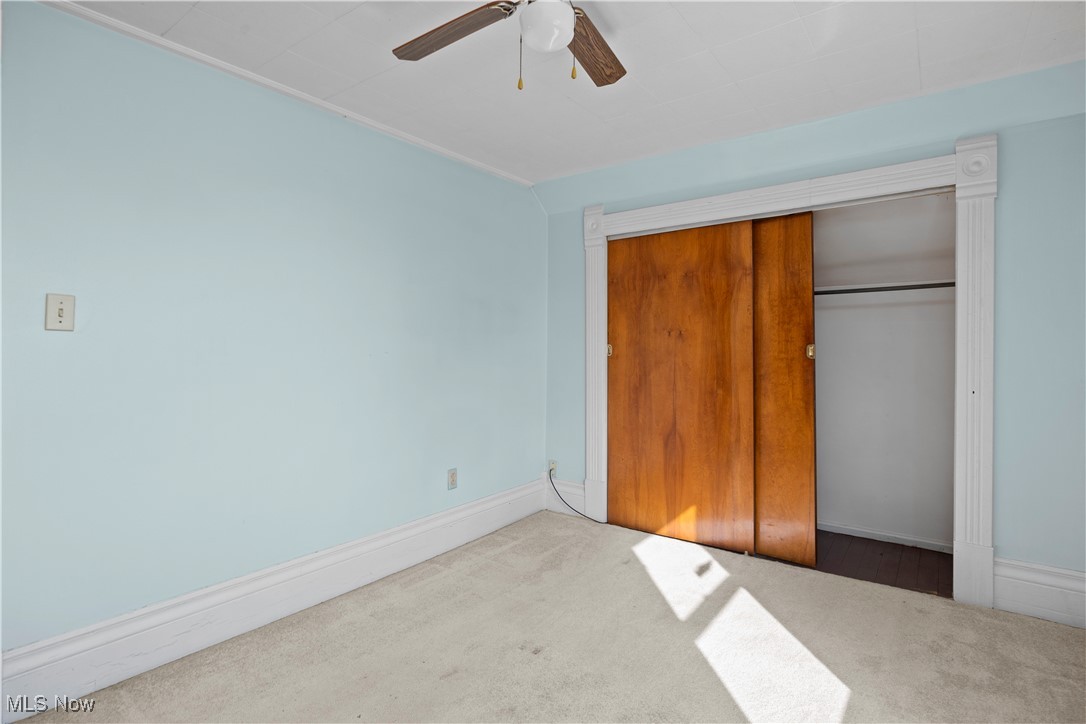 6927 North Wildacre Road Curtice, OH 43412 - Photo 26 of 44 Unfurnished bedroom with carpet, a closet, and a ceiling fan