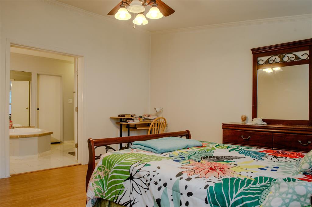 1468 Cedar Mills Road Gordonville, TX 76245 - Photo 18 of 35 a bedroom with a bed and a chandelier