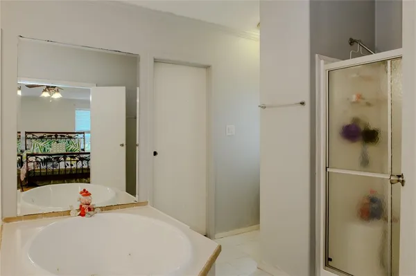 a bathroom with a tub and shower