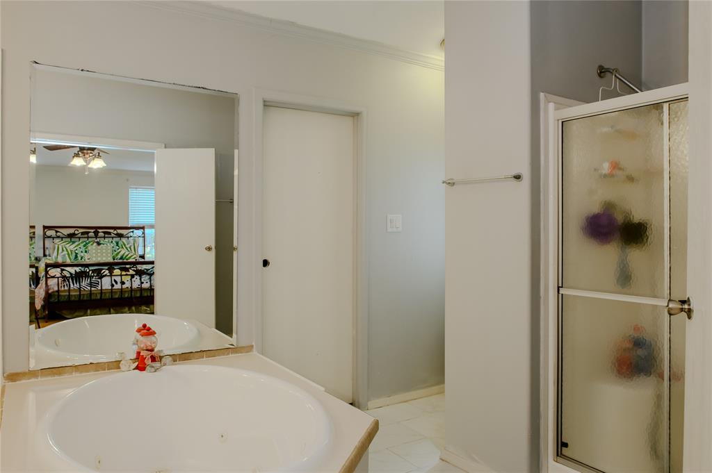 1468 Cedar Mills Road Gordonville, TX 76245 - Photo 19 of 35 a bathroom with a tub and shower