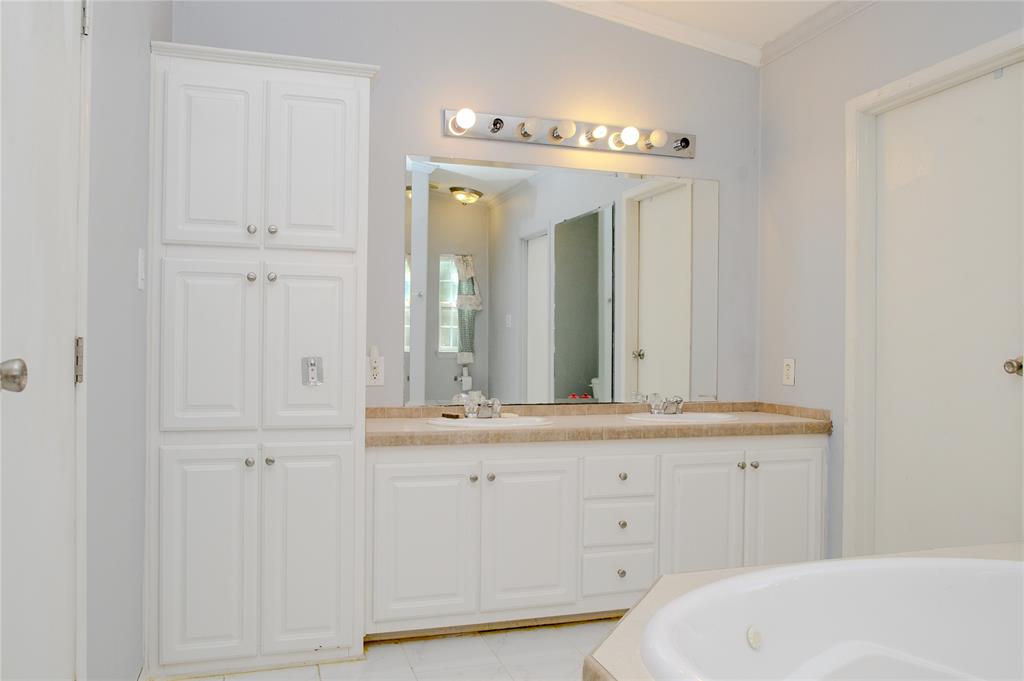 1468 Cedar Mills Road Gordonville, TX 76245 - Photo 21 of 35 a bathroom with a double vanity sink and mirror