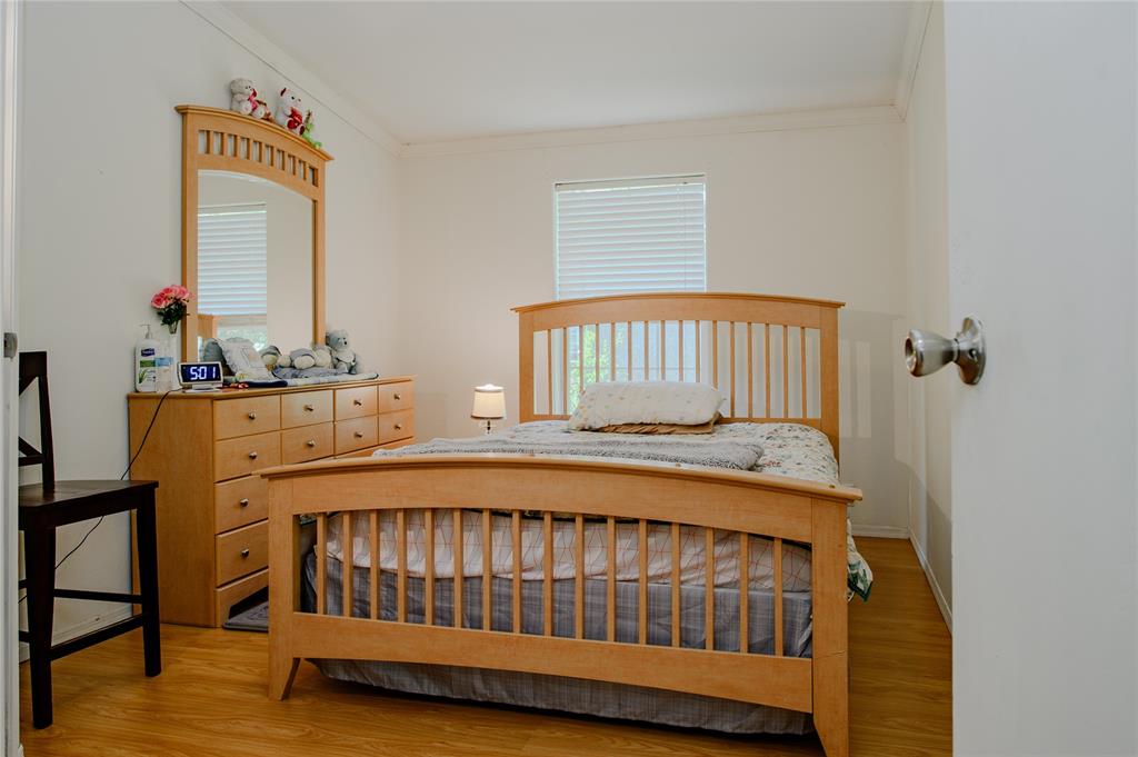 1468 Cedar Mills Road Gordonville, TX 76245 - Photo 25 of 35 a bedroom with a bed and wooden floor