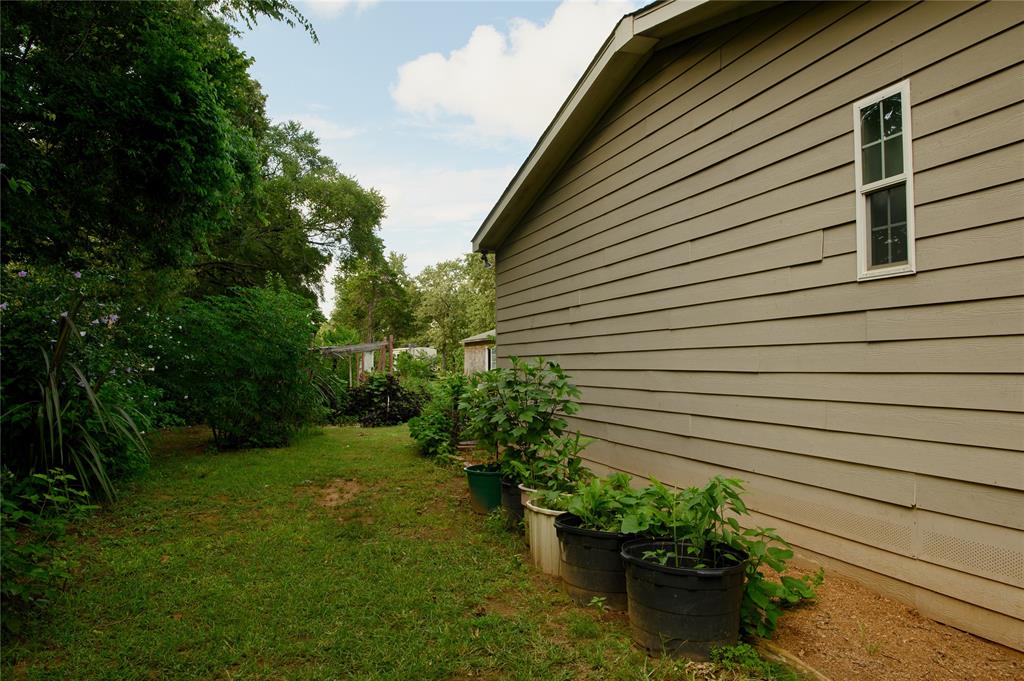 1468 Cedar Mills Road Gordonville, TX 76245 - Photo 32 of 35 a backyard of a house with lots of green space