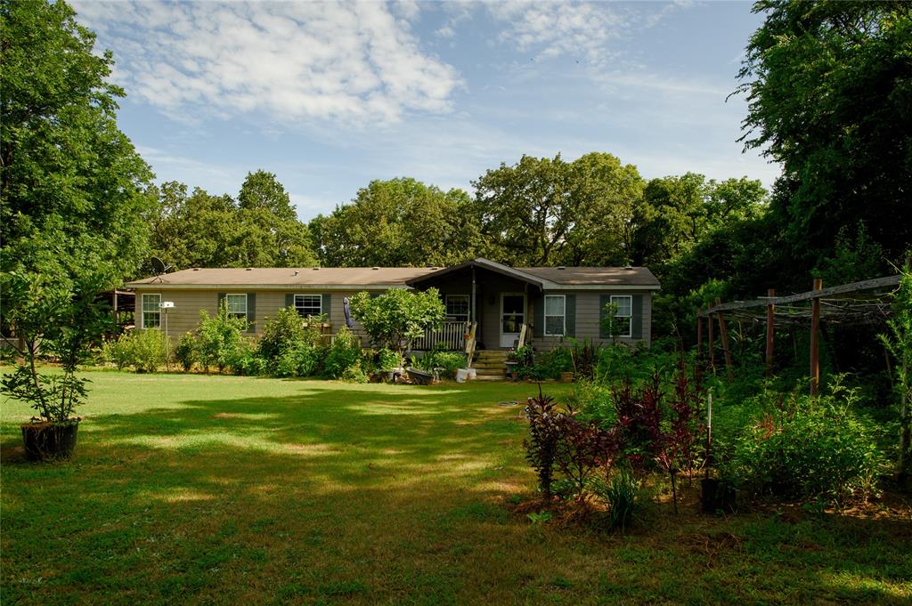 1468 Cedar Mills Road Gordonville, TX 76245 - Photo 4 of 35 a front view of a house with a yard and trees