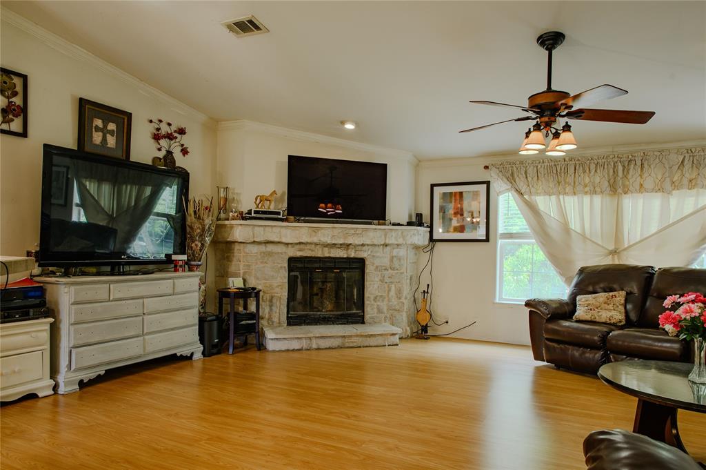 1468 Cedar Mills Road Gordonville, TX 76245 - Photo 7 of 35 a living room with furniture a flat screen tv and a fireplace