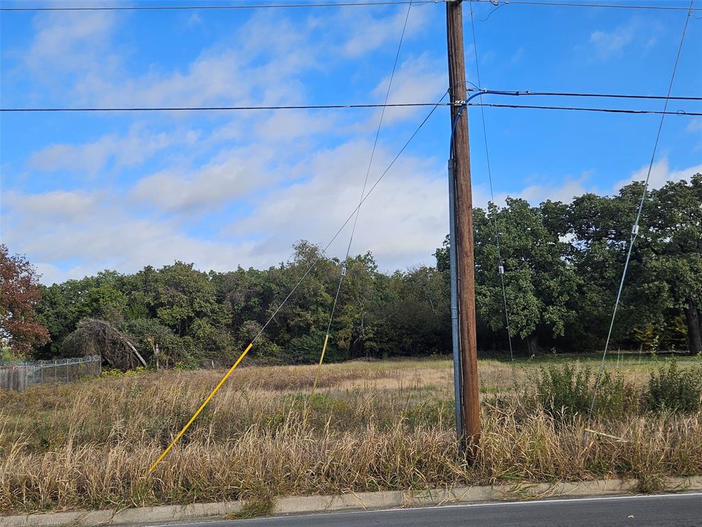 7609 John T White Road Fort Worth, TX 76120 - Photo 2 of 4 View of asphalt road with curbs and a view of trees